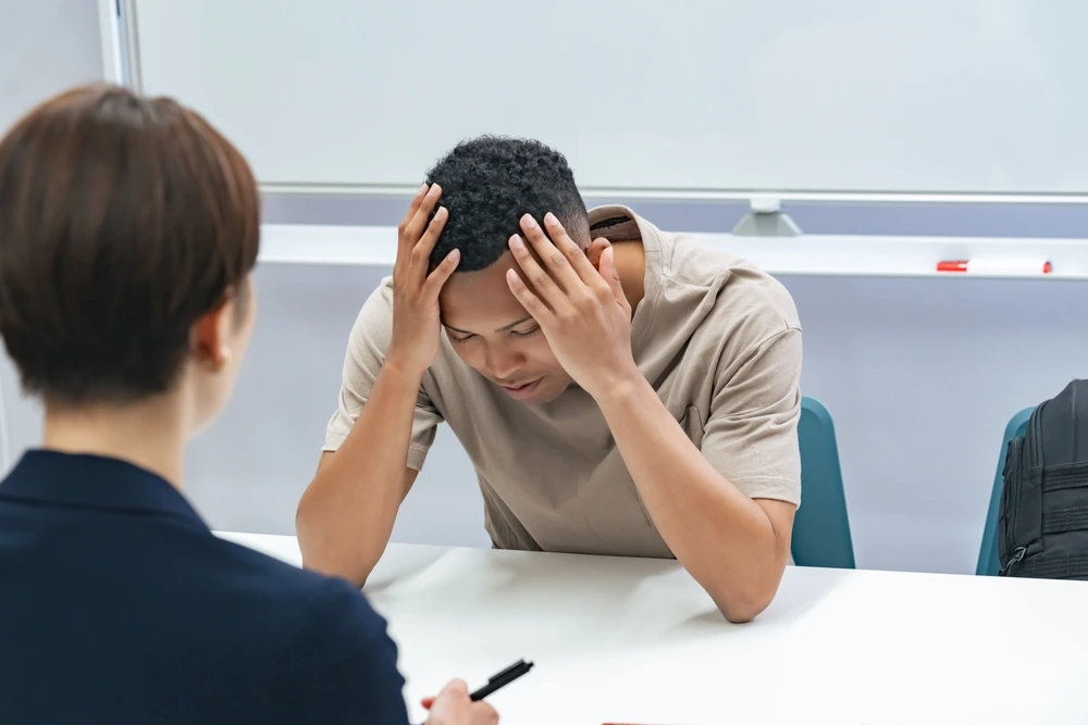 Visa rejection, young man worried infront of visa officer