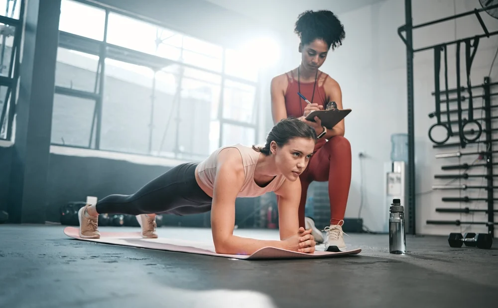 female personal trainer training young female