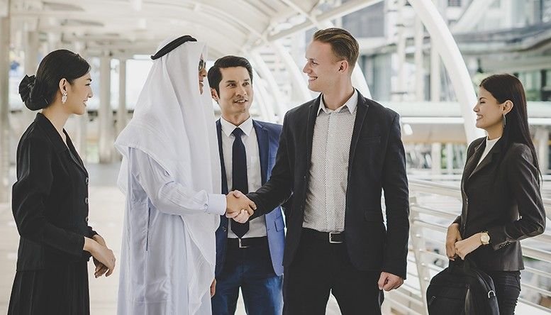 Business partners shaking hand in UAE
