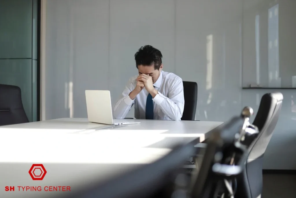 stressed employer sitting on meeting table